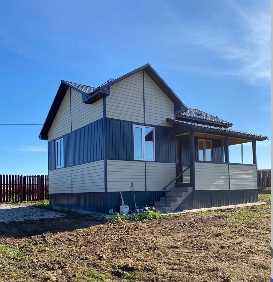 Finished timber-frame house with siding and a roofed terrace